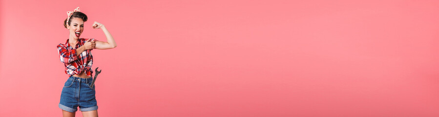 Gorgeous strong young pin-up woman showing biceps.