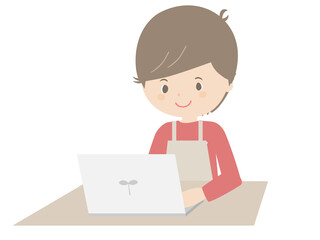 ノートパソコンを見るエプロンをつけた若い男性