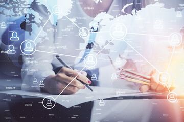 Social network theme hologram over hands taking notes background. Concept of global international people connect. Double exposure