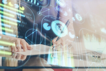 Double exposure of woman's writing hand on background with data technology hud. Big data concept.
