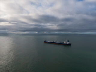 an oil tanker anchored during the day in cloudy weather