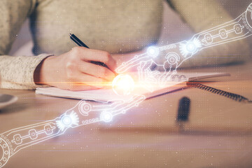 Double exposure of writing hand on background with data technology hologram. Big data concept.