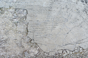 The surface of the cement is gray with areas of destruction