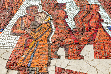 Multicolored mosaic panel of red-orange smalt, elements of the old Soviet monument