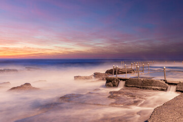 Water flowing around the rocks at Avalon Beach coastline, Sydney, Australia.