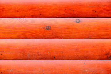 The wall of the building is made of wooden logs painted with red paint. A modern building in classical Slavic architecture