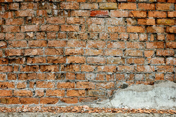 A wall of very old brick red-orange and brown with destruction. Texture