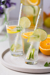 Water with fresh orange, lemon and lime slices.