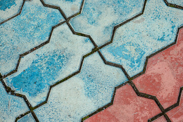 Streetlights and texture of different colored patterned paving slabs on the ground of street,...