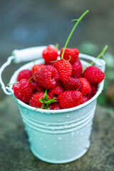 fresh raspberries in basket. Berries in garden. Organic healthy food. Fruits.