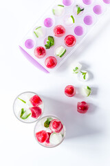 Fototapeta na wymiar Raspberry and lime in ice cubes top view flat lay