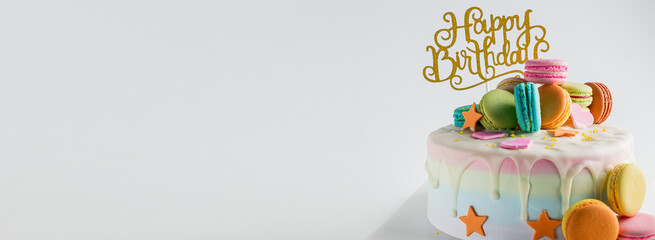 White Birthday cake and colourful Macaroon over light grey.food concept anniversary background.
