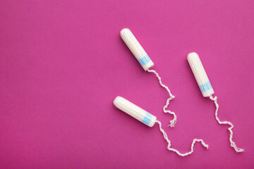 Menstrual tampons on a pink background. Cotton tampon for women