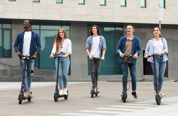 Friends having nice ride on motorized scooters