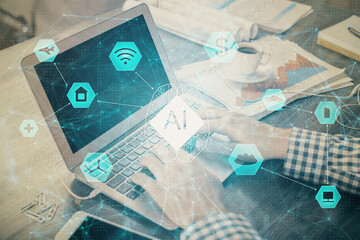 Businessman with computer background with technology theme hologram. Concept of hightech. Multi exposure.