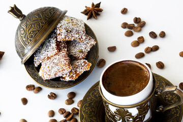 Turkish coffee with traditional turkish dessert cezerye and copper serving set. Feast of Ramadan. Cezerye is made with boiled carrots, sugar, pistachio and coconut. It is located dessert of  Mersin.