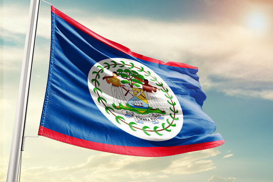 belize national flag cloth fabric waving on the sky with beautiful sun light - Image
