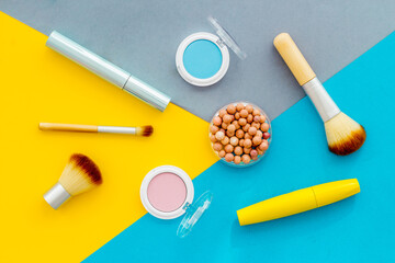 Beauty cosmetics and makeup products on colorful background. Flat lay, top view