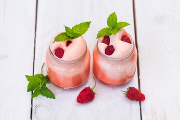 Fruit yogurt for Breakfast. With slices of raspberries, blueberries and blackberries in nature