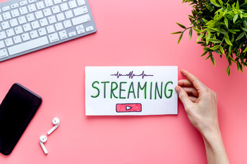 Live streaming web network concept. Female hands holding paper tablet. Top view