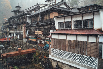 Fototapeta premium Yamagata, Japan - Nov 16, 2017: Ginzan Onsen first snow of Japanese famous hot spring town in Obanazawa City, Yamagata, Japan.
