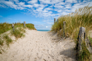 View of the sand dunes and sea on a summer sunny day. Baltic Sea, Heiligenhafen, Germany