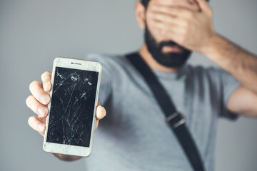 sad man hand broken phone