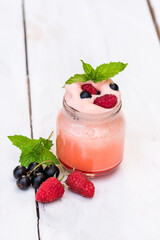 Homemade morning yogurt with fruits and berries in nature.