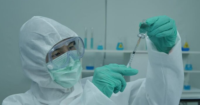 Medical examiner holds a blood sample vial at an Indian testing lab for treating coronavirus cases