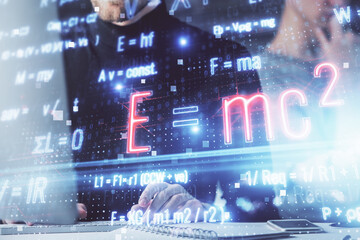 Science formula hologram with man working on computer on background. Education concept. Double exposure.