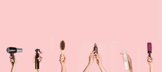 Collage with female hands holding different hair care products and equipment over pink background,...