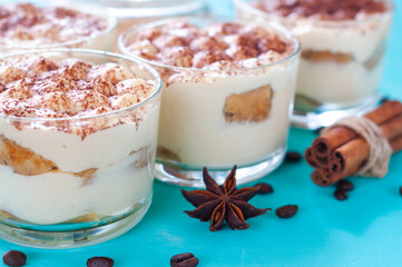 classic Italian dessert tiramisu in glasses, decorated with cocoa powder