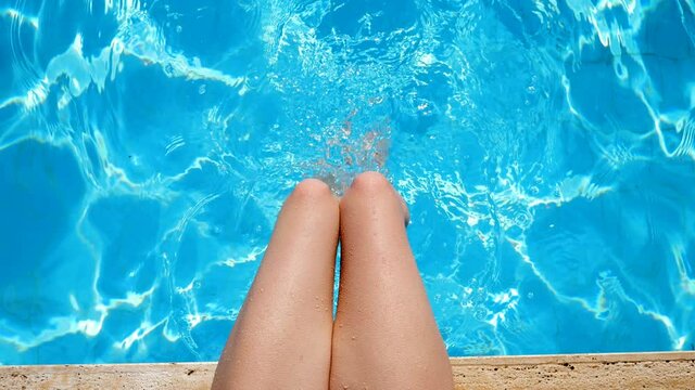 Relax,summer,holidays.young woman 's leg playing with swimming pool water