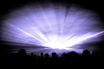 Purple laser show nightlife club stage with party people crowd. Luxury entertainment with audience silhouettes in nightclub event, festival or New Years Eve. Beams and rays shining colorful lights
