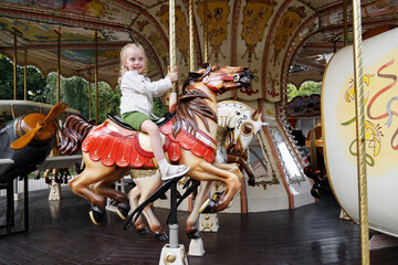 Little girl in an amusement park rides