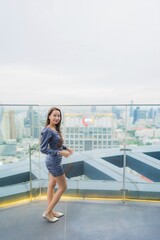 Obraz premium Portrait beautiful young asian woman happy smile on roof top restaurant