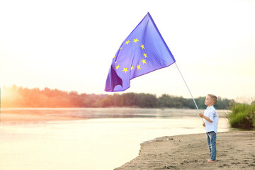 A young boy holds the flag of the European Union