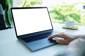 Mockup image of a businesswoman using and touching on laptop touchpad with blank white desktop screen in the office