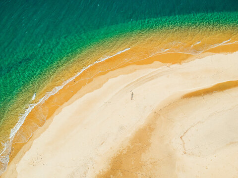 Shadow Of A Single Person On A Beach Seen From High Above