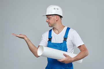 an adult male in a White construction helmet. holding an imaginary house in the palm of your hand.