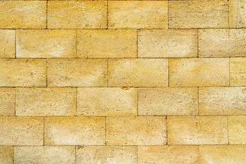 Old vintage yellow brick wall textured background.