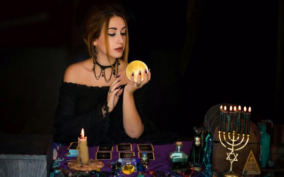  Woman fortune teller on a crystal ball, Concept of predictions, magic rituals and wicca