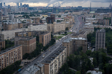 a view of a big city through the window where you can see that it is raining outside