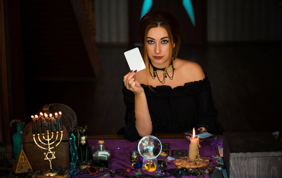  Woman holding white tarot card, Concept of predictions, magic rituals and wicca 