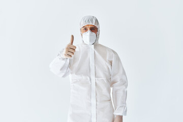 Fototapeta na wymiar Doctor in protective medical suit showing thumbs up