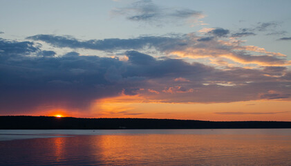Fototapeta na wymiar Sunset on the shore of a small lake