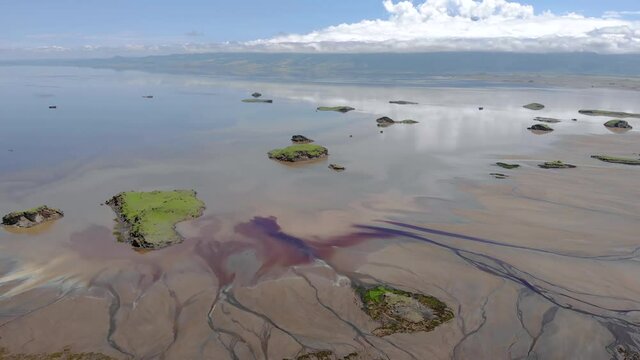 Aerial Flyby view on the islands at Lake Natron in the Great Rift Valley, between Kenya and Tanzania. In the dry season the lake is 80% covered by soda and is known for its wading birds and huge