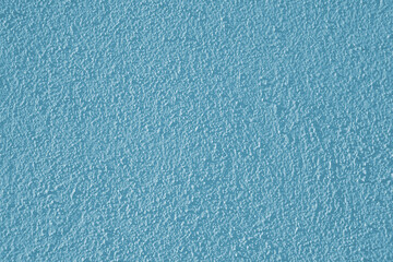 Low contrast texture of a blue plastered wall.