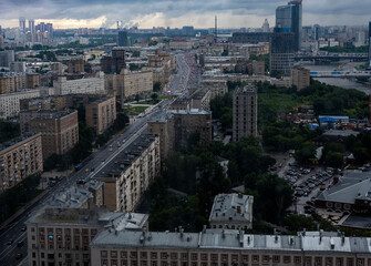 a view of a big city through the window where you can see that it is raining outside