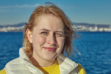 Portrait of young caucasian woman near the sea.